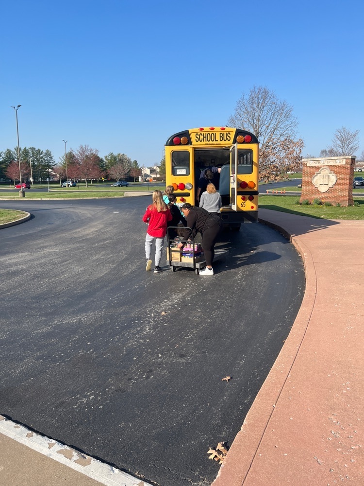 Central Service loading the bus with canned food.